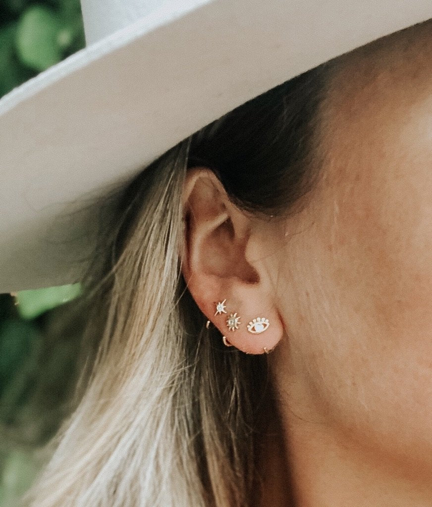 Evil eye on sale huggie earrings